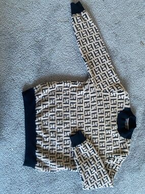 A replica of a Fendi Beige & Black FF Logo Knit Sweater